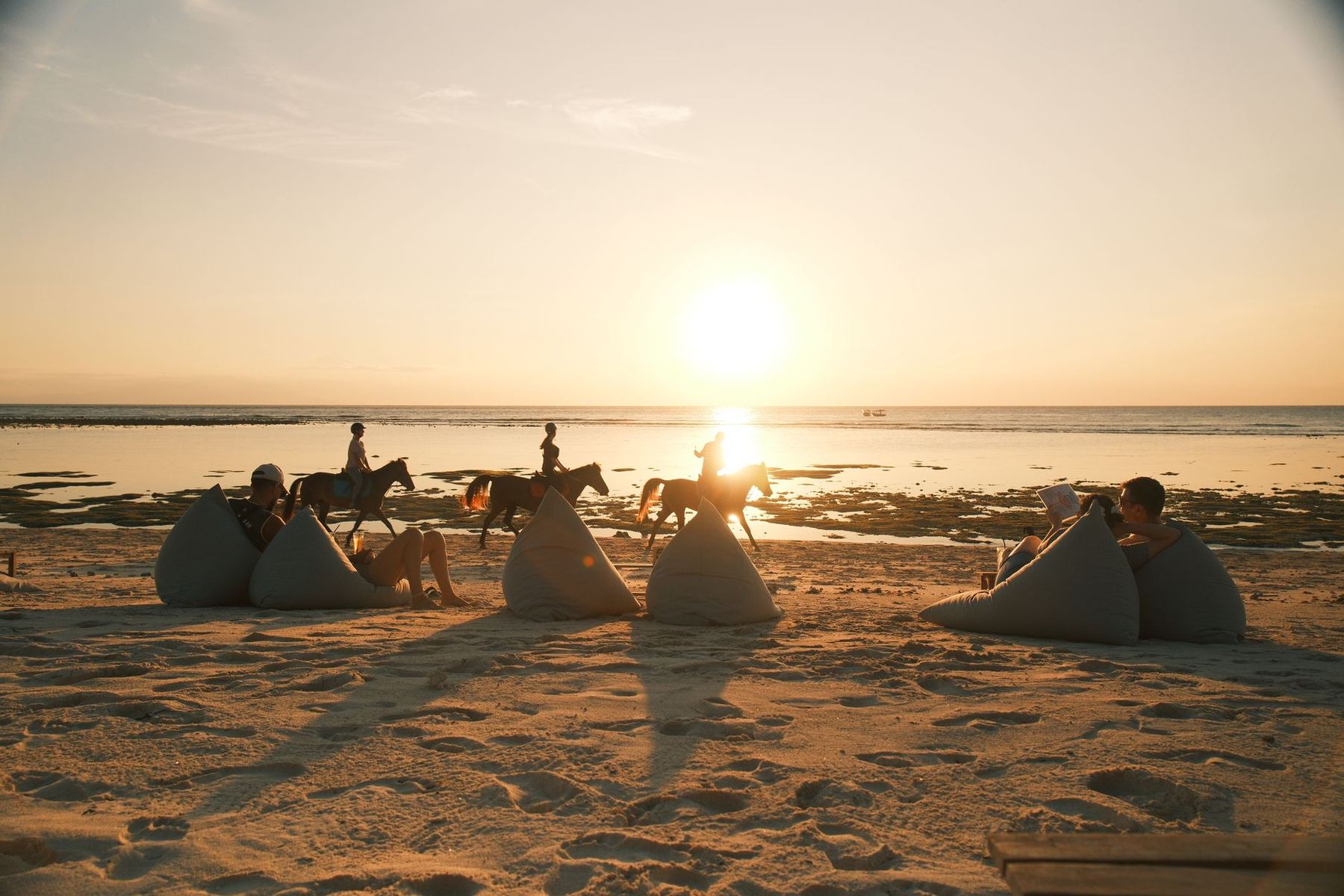 People on a beach at sunset, West Nusa Tenggara